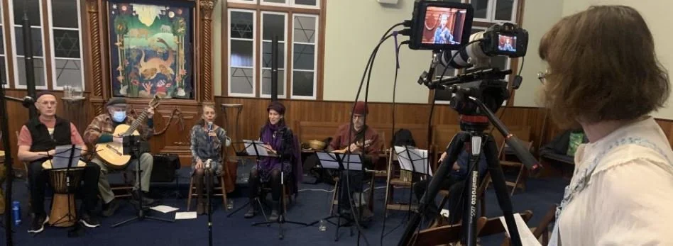 Chanting & Chocolate musicians being filmed during a live performance
